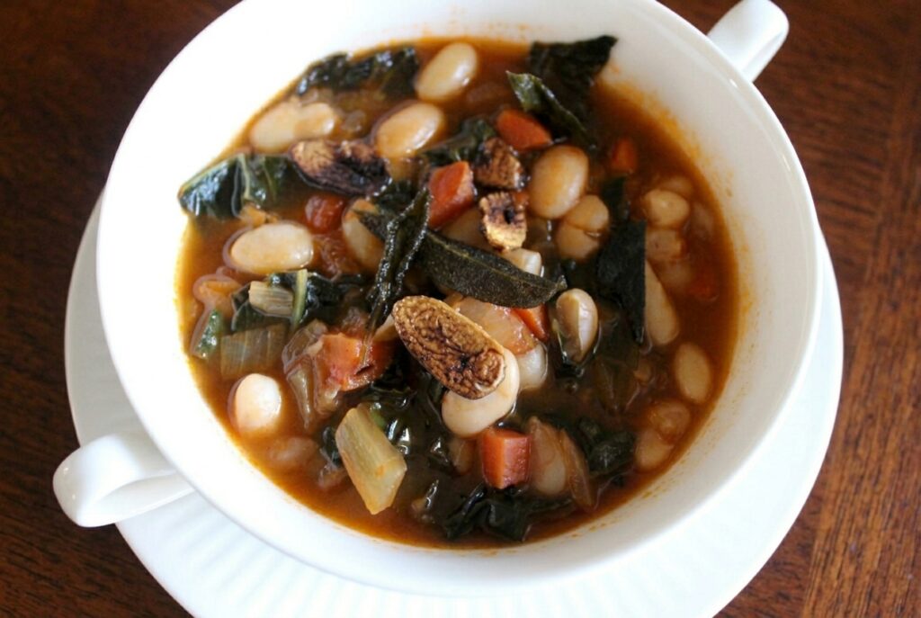 white bean kale soup in white bowl